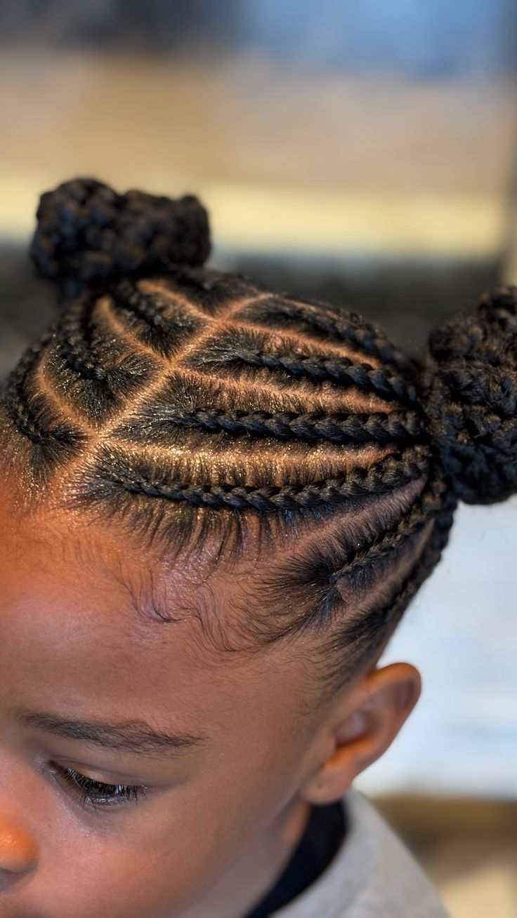 Star pattern cornrows with space buns